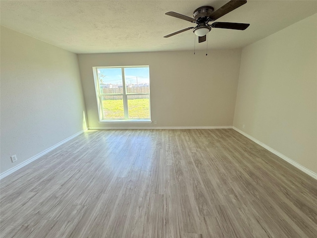 empty room featuring light hardwood / wood-style floors and ceiling fan