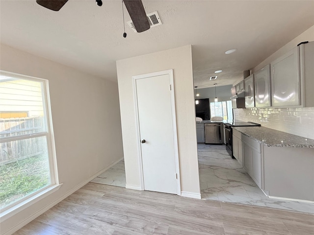 kitchen with black electric range oven, tasteful backsplash, hanging light fixtures, dishwasher, and light stone countertops