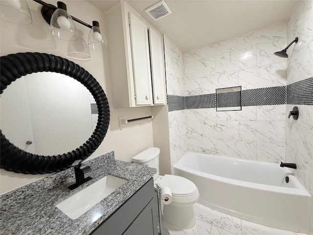 full bathroom with tiled shower / bath, vanity, and toilet