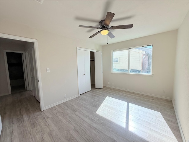 unfurnished bedroom featuring a closet, ceiling fan, and light hardwood / wood-style flooring