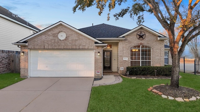 view of front facade featuring a garage and a lawn