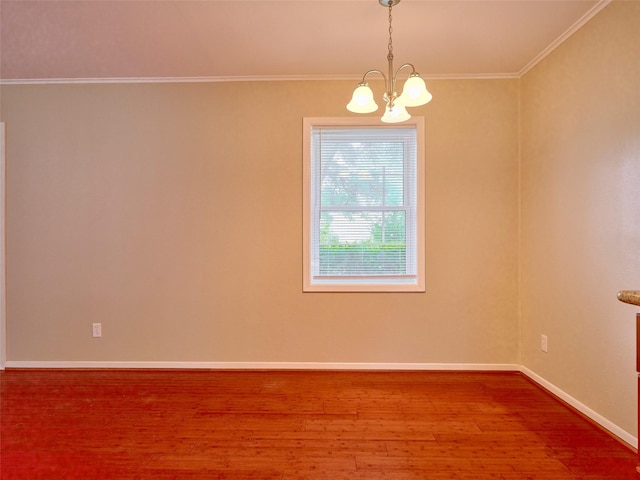 unfurnished room featuring an inviting chandelier, hardwood / wood-style floors, and ornamental molding