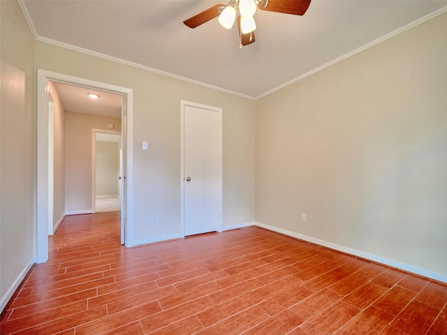 unfurnished bedroom featuring hardwood / wood-style flooring, ornamental molding, and ceiling fan