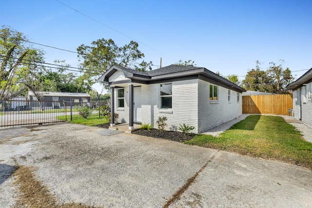 bungalow-style house with a patio and a front yard