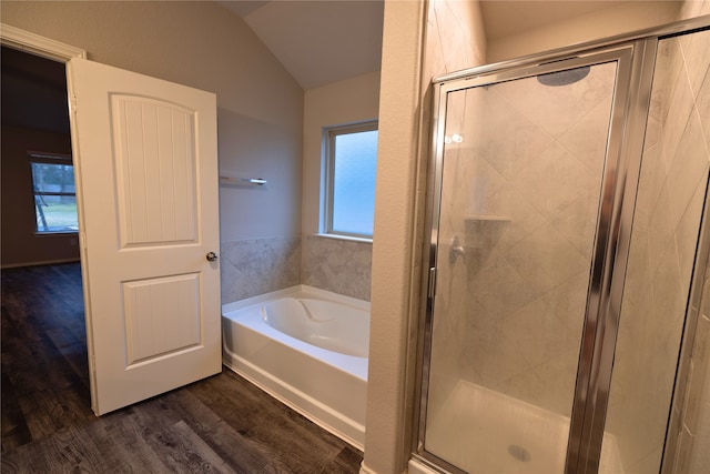 bathroom with lofted ceiling, hardwood / wood-style floors, and separate shower and tub