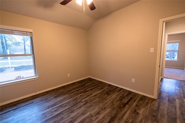 empty room featuring ceiling fan, lofted ceiling, and dark hardwood / wood-style floors