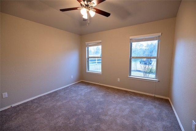 carpeted empty room featuring vaulted ceiling, a wealth of natural light, and ceiling fan