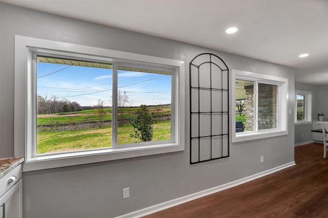 unfurnished dining area featuring dark hardwood / wood-style flooring