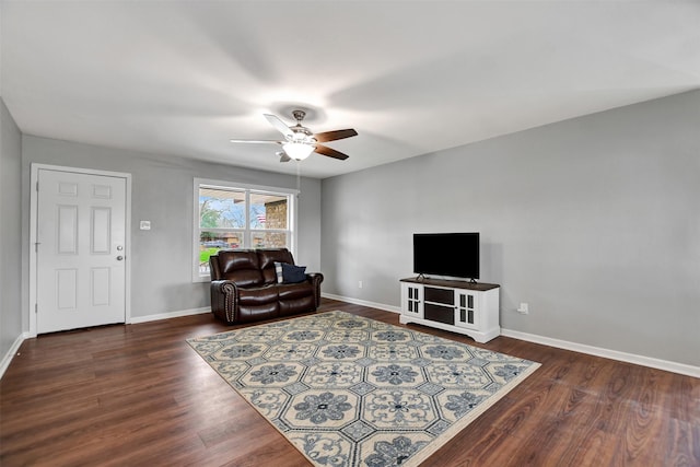 living room featuring ceiling fan and dark hardwood / wood-style flooring