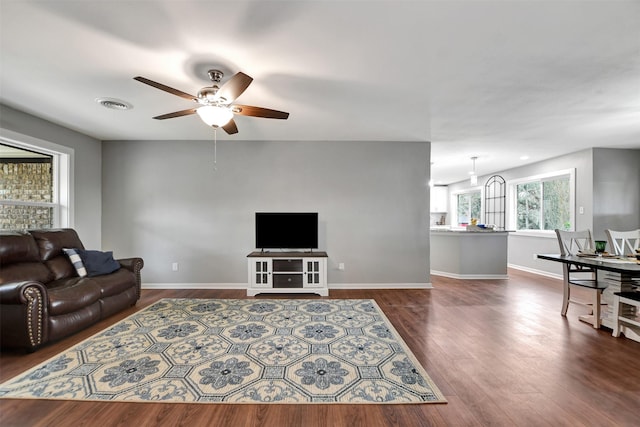 living room featuring dark hardwood / wood-style floors and ceiling fan