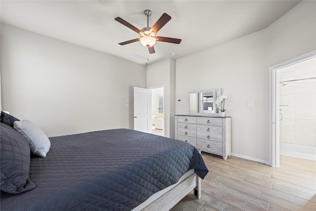 bedroom with ceiling fan and ensuite bath