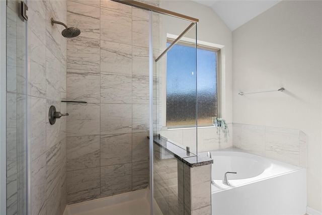 bathroom featuring vaulted ceiling and separate shower and tub