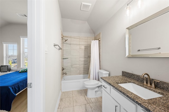 full bathroom with lofted ceiling, shower / tub combo, vanity, and toilet