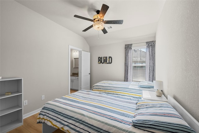 bedroom with ensuite bathroom, vaulted ceiling, ceiling fan, and light hardwood / wood-style floors