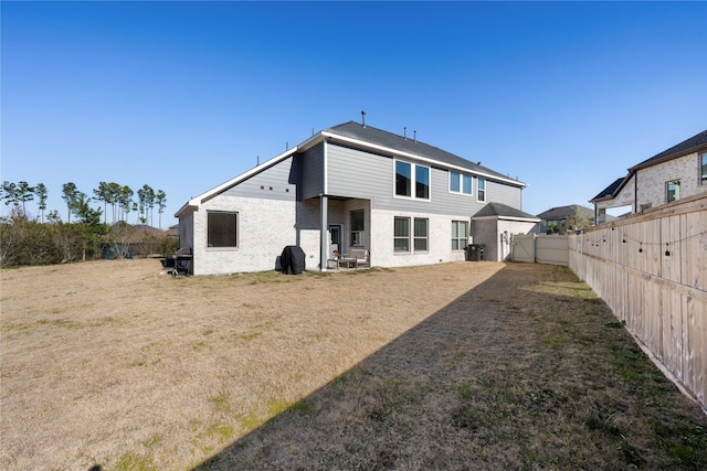 rear view of property with a yard