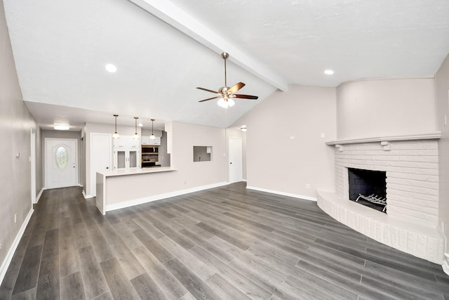 unfurnished living room featuring lofted ceiling with beams, ceiling fan, dark hardwood / wood-style floors, and a fireplace