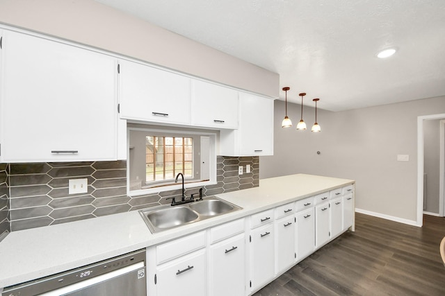 kitchen featuring sink, dishwasher, white cabinetry, hanging light fixtures, and tasteful backsplash