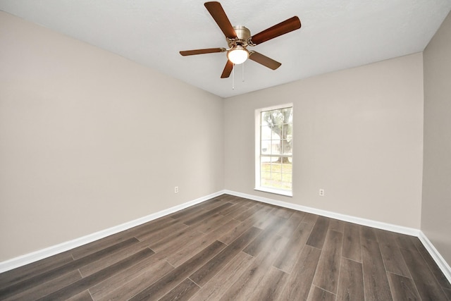 spare room featuring ceiling fan and dark hardwood / wood-style flooring