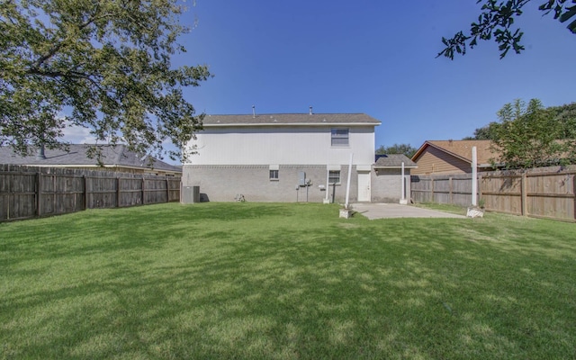 back of property featuring a patio, central AC, and a lawn