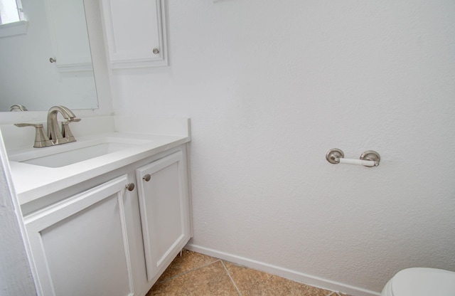 bathroom featuring vanity, toilet, and tile patterned flooring