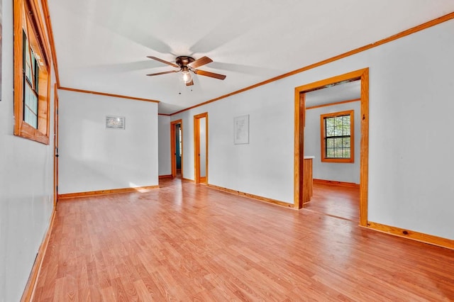 empty room with ceiling fan, ornamental molding, and light wood-type flooring