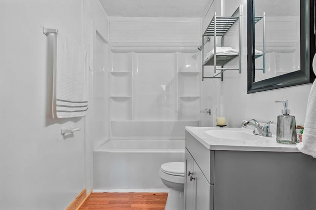 full bathroom featuring vanity, hardwood / wood-style floors, shower / bathing tub combination, and toilet