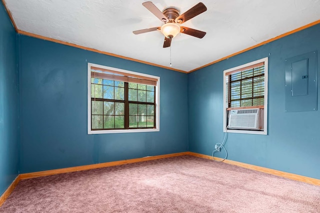 carpeted empty room with crown molding, electric panel, cooling unit, and a wealth of natural light