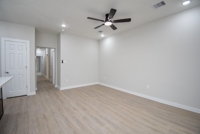 spare room with ceiling fan and light wood-type flooring