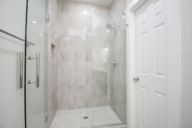 bathroom with a shower with shower door