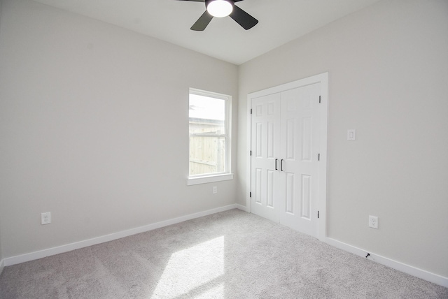 unfurnished bedroom with a closet, ceiling fan, and carpet