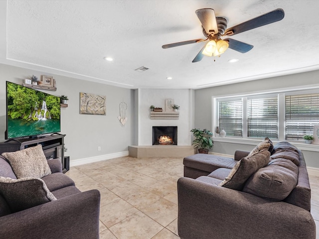 tiled living room featuring a textured ceiling and ceiling fan