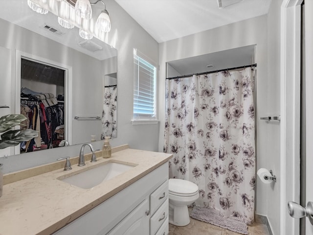 bathroom featuring vanity, curtained shower, tile patterned floors, and toilet