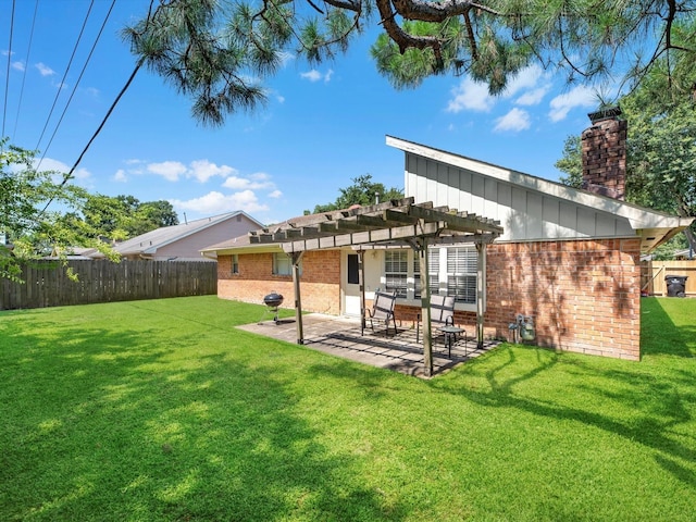 rear view of property with a patio, a lawn, and a pergola