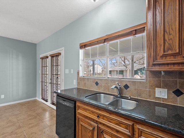 kitchen with a sink, baseboards, black dishwasher, brown cabinets, and tasteful backsplash