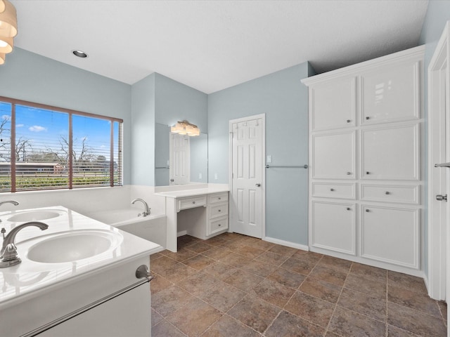 full bath with double vanity, a sink, baseboards, and a bath