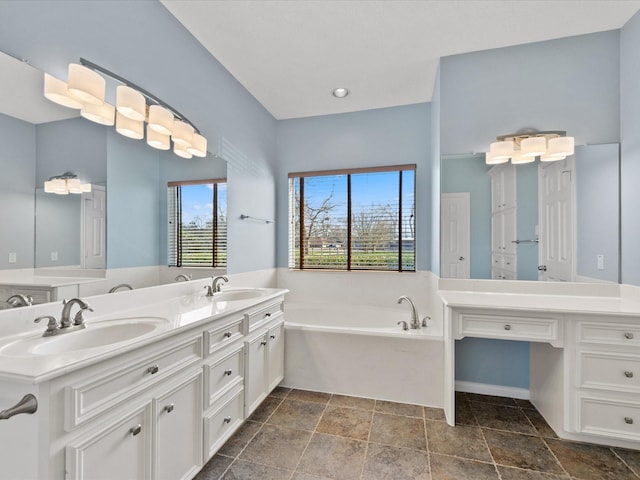 full bathroom featuring double vanity, a garden tub, and a sink