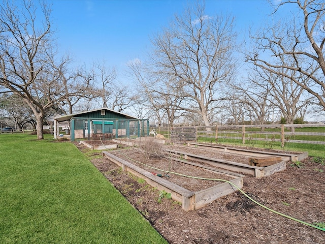 view of yard with a rural view, an outdoor structure, and a garden