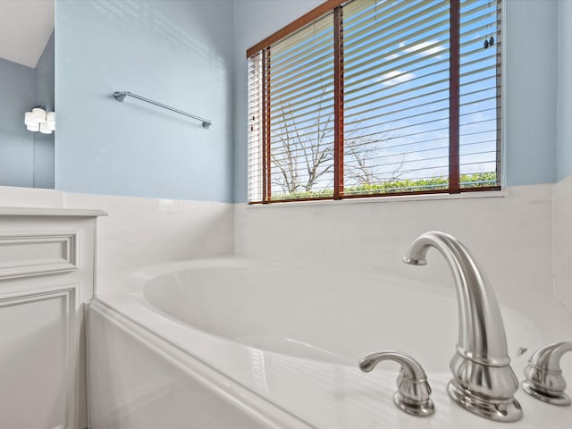 bathroom with a garden tub and plenty of natural light