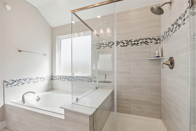 bathroom featuring lofted ceiling and shower with separate bathtub