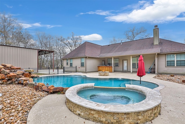 view of swimming pool featuring an in ground hot tub and a patio area