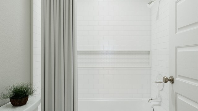 details with tiled shower / bath combo