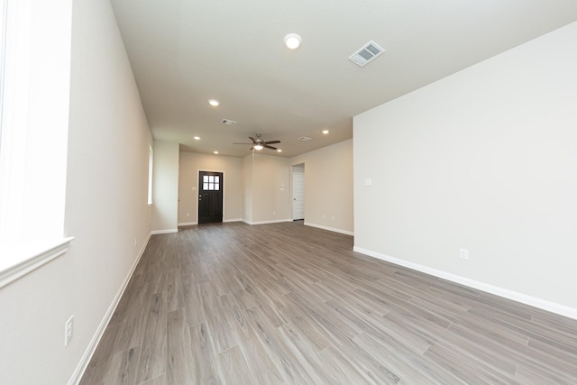 spare room with light wood-style flooring, visible vents, baseboards, and recessed lighting