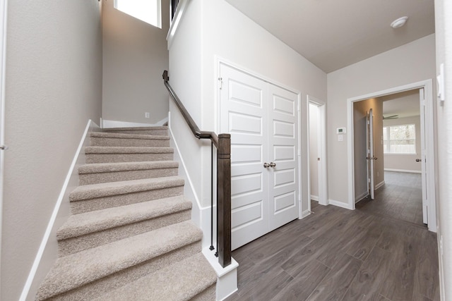 stairway featuring baseboards and wood finished floors