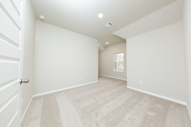 unfurnished room featuring light carpet, baseboards, visible vents, and recessed lighting