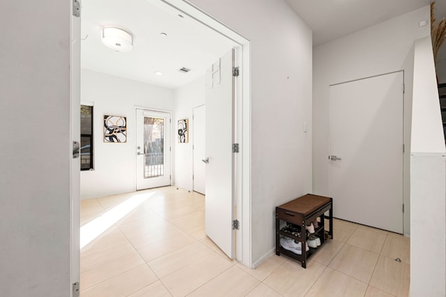 hallway with light tile patterned floors