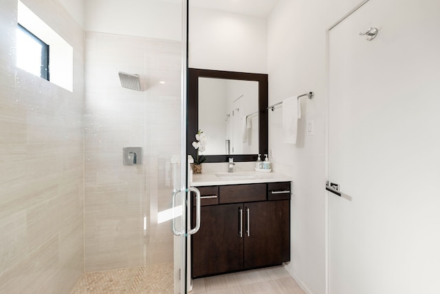 bathroom featuring tile patterned floors, vanity, and an enclosed shower