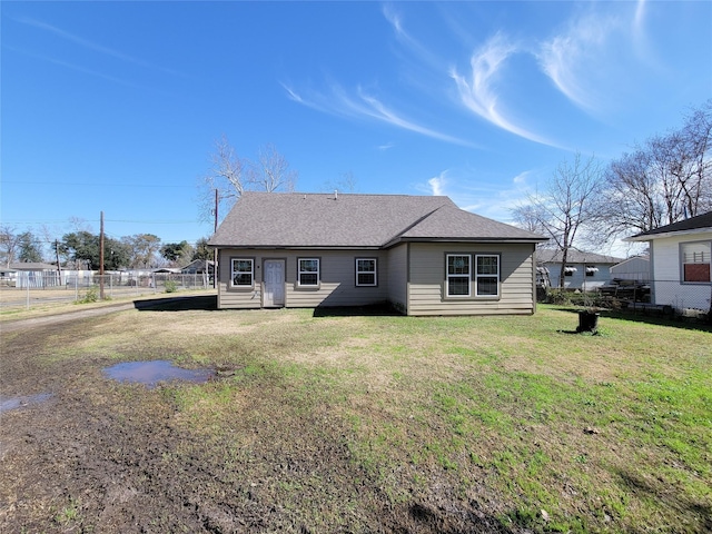 rear view of house featuring a lawn