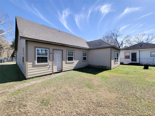 back of house with a lawn