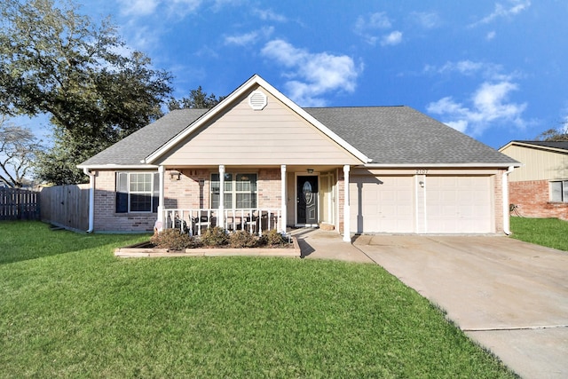 view of front of home featuring a porch, a garage, and a front yard