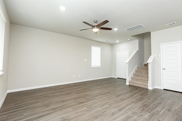 spare room with ceiling fan and dark hardwood / wood-style floors